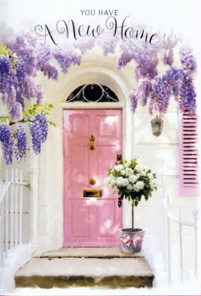 Stepping up to this inviting doorway in Grays, you are greeted first by the soft glow of a painted pink door, its colour somewhere between blush and rosewater, and then by the intoxicating sight of wisteria tumbling overhead in cascades of lavender and lilac. The blossoms hang like fragrant curtains above the entrance, suggesting early summer along the quieter residential streets that wind away from Grays town centre, when gardens are lush and every walk feels a little more romantic. The walls around the door are whitewashed and gently textured, catching the filtered light and sending it back in a diffuse, flattering glow. At the threshold rests a stylish, slightly weathered tin bucket, filled to the brim with creamy white roses and tender green foliage, arranged with the kind of care only an experienced florist would give. Each rose is plump and open, their petals layered like folded silk, and they nestle together in a harmonious cluster. A satin ribbon in a soft, dusty pink wraps around the bucket, its bow trailing gracefully and echoing the colour of the door. The whole composition feels like a quiet pause between past and future, the exact moment when a new house near Grays Beach or Parker Road starts to become a home. You can almost imagine the slight rustle of leaves, the faint sweetness of the roses mingling with the wisteria, and the hush of anticipation, making this arrangement perfect for marking a move, offering congratulations, or simply saying, May this doorway always feel warm and welcoming.